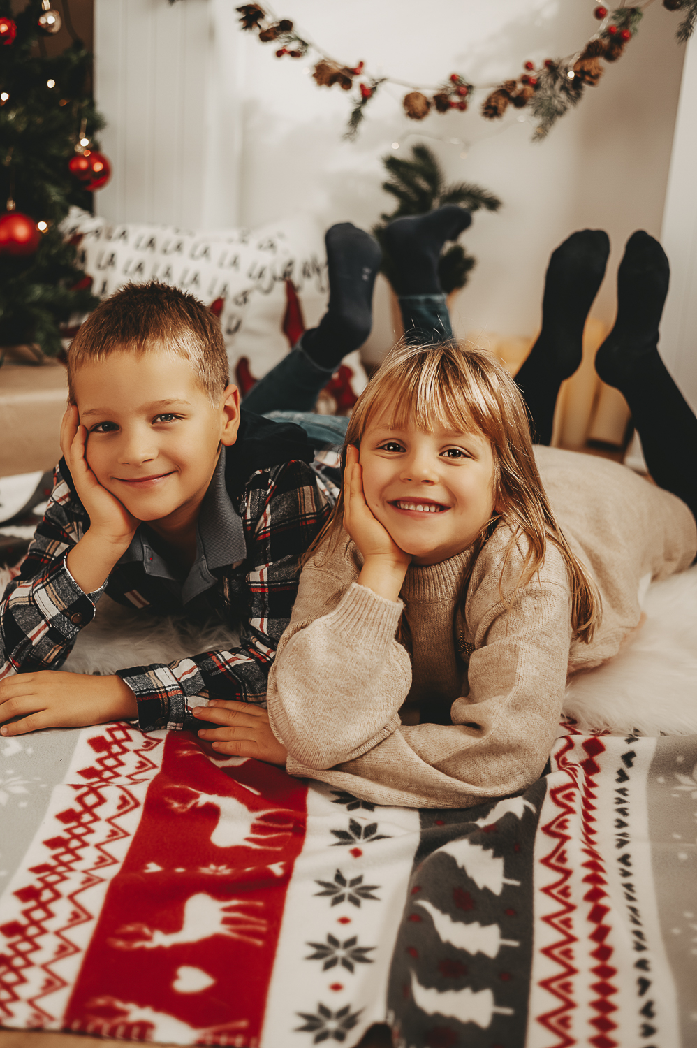 Zwillinge liegen auf einer weihnachtlichen Decke Familienfotografie Wetterau